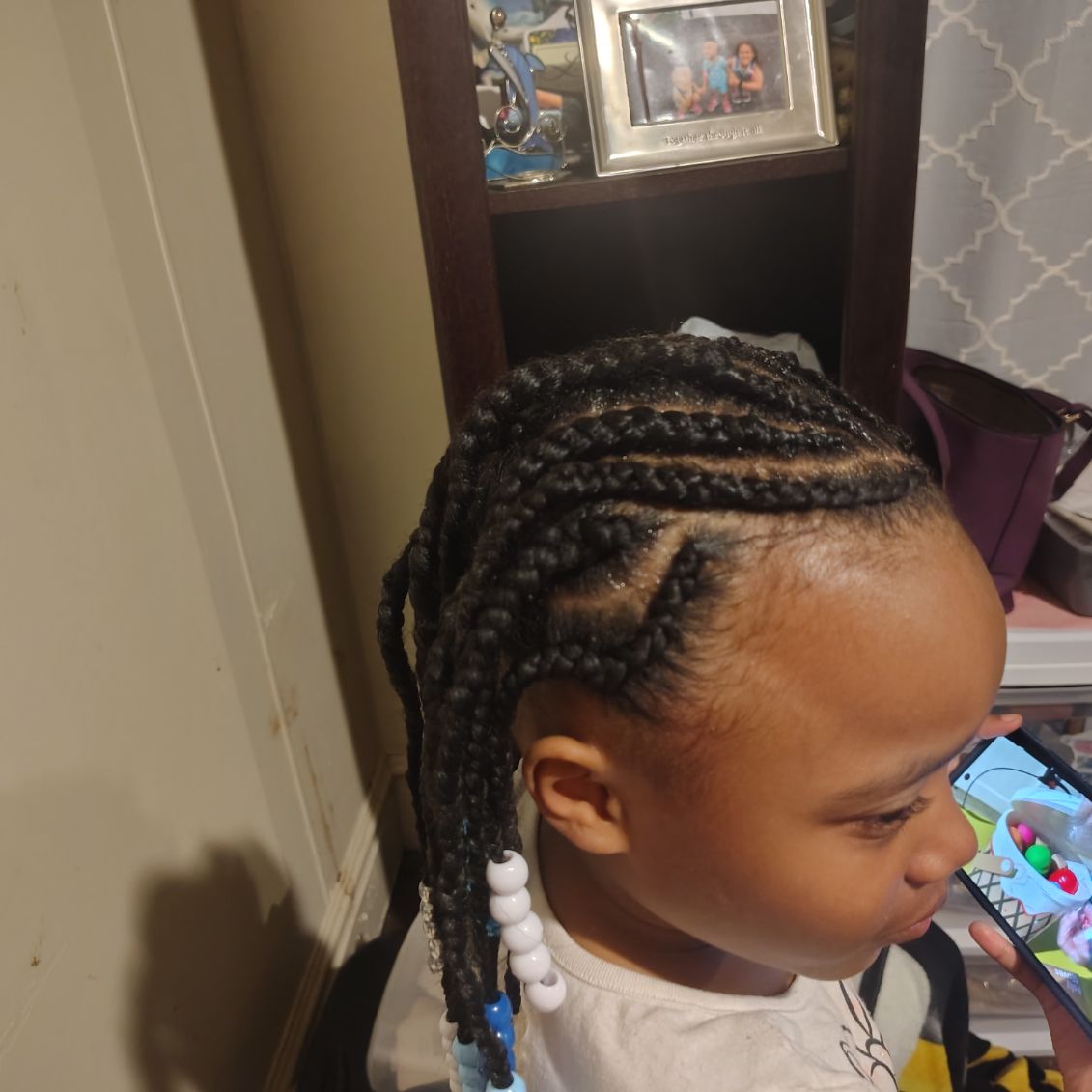 Cornrows ending in small braids with white and blue beads